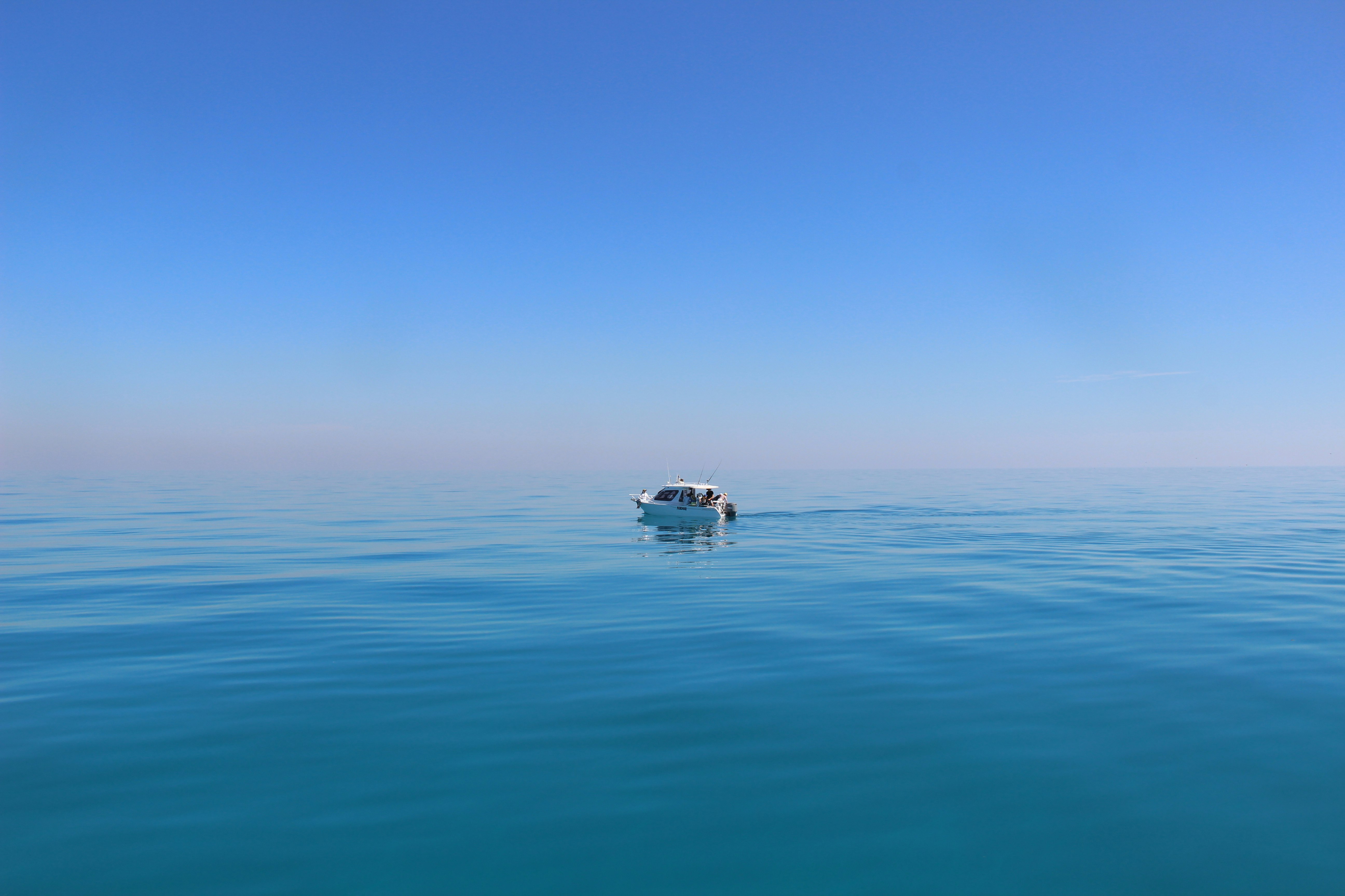 white boat under blue sky photography